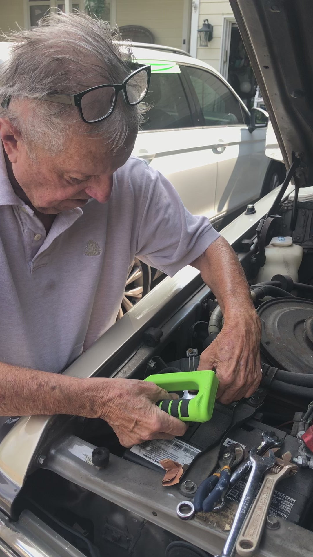 Load video: man fixing battery with hammer-fist tool